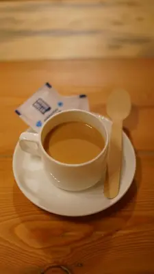 a cup of coffee on a plate with a spoon at Royal Adventures in Kodaikānāl