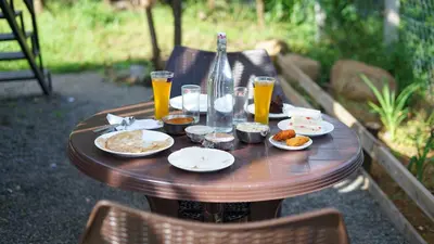 a wooden table with food and drinks on it at Royal Adventures in Kodaikānāl