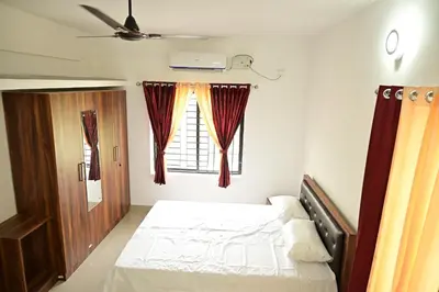 a bedroom with a bed and a window at Geetham Villas in Palakkad