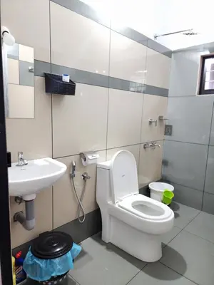 a bathroom with a toilet and a sink at Olive Home stay Gold 1bhk in Alwaye