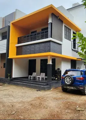 a blue car parked in front of a house at Olive Home stay Gold 1bhk in Alwaye