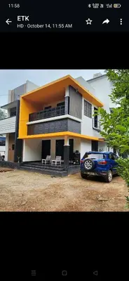 a blue car parked in front of a house at Olive Home stay Gold 1bhk in Alwaye