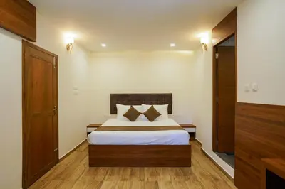 a bedroom with a bed in a room at Grand Plaza Inn in Kottakkal