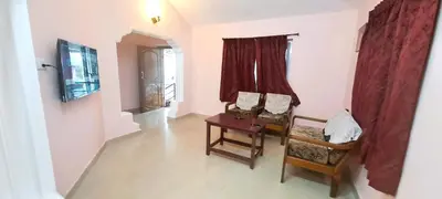 a living room with two chairs and a table at iSTAYS - Kodai Villa in Kodaikānāl