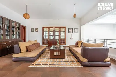a living room with two couches and a coffee table at StayVista at Wellbeing Villa in Wayanad