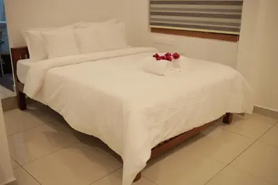 a white bed with two towels on top of it at Humblebee Retreat Tattekkad in Kuttampuzha