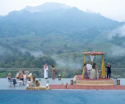 a wedding ceremony on the edge of a pool at The Grand Cliff Resort Munnar in Viripara
