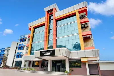 a building with a sign on the front of it at Super Townhouse Mysore Central in Mysore