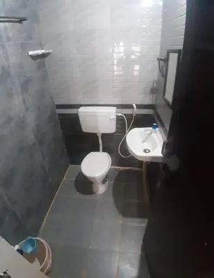 a small bathroom with a toilet and a sink at Renu Residency on the way to Isha yoga centre and near Maruthamalai in Marudhamalai