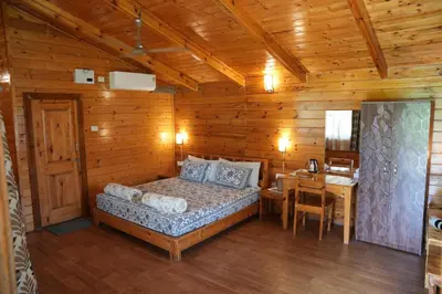 a bedroom with a bed in a wooden cabin at labdhi Resorts Masinagudi- Stag Groups not allowed in Masinagudi