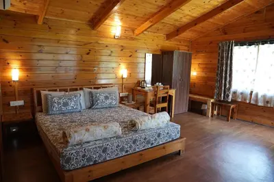 a bedroom with a bed in a wooden cabin at labdhi Resorts Masinagudi- Stag Groups not allowed in Masinagudi