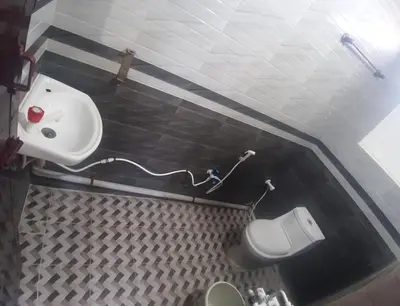 a bathroom with a sink and a toilet at Renu Residency near Maruthamalai and on the way to Adiyogi Isha yoga Centre in Marudhamalai