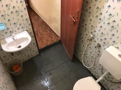a small bathroom with a sink and a toilet at Angel Valley in Trichūr