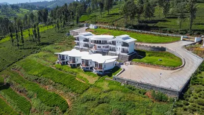 an aerial view of a large house on a hill at COASTAL GRAND RESORT - KOTAGIRI in Kotagiri