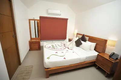 a bedroom with a large bed with a phone on it at Feel Free Retreat in Kalpetta