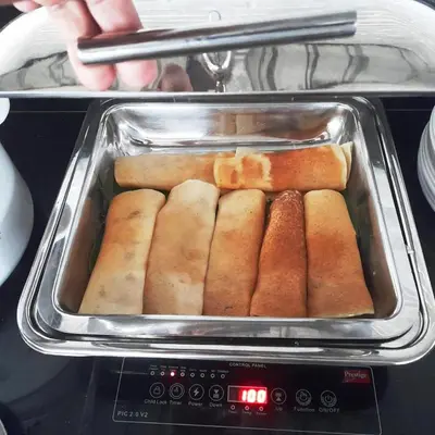 a tray of hot dogs in an oven at Hotel Roopa in Mysore