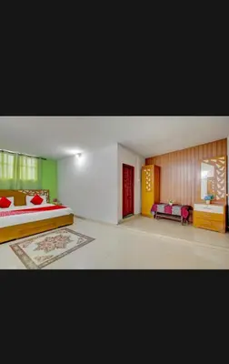 a bedroom with a bed and a couch in it at HILL BIRD HOME STAY Ooty in Ooty