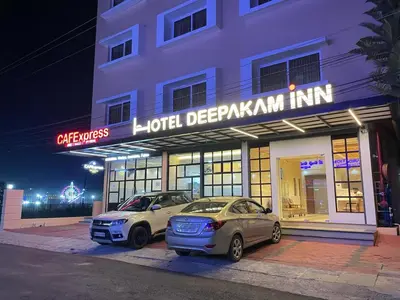 two cars parked in front of a hotel at night at Hotel Deepakam Inn in Palakkad