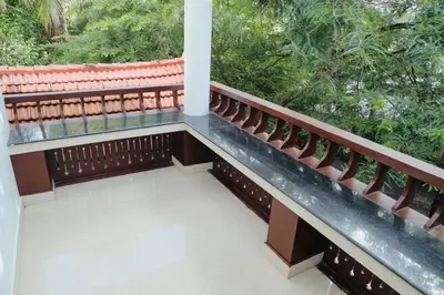 a balcony of a house with trees at Sankalpa Homestay in North Paravur