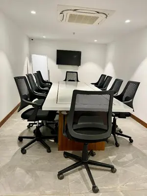 a conference room with a table and chairs at Gokulam Park Guruvayur in Guruvāyūr