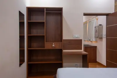 a bedroom with wooden shelves and a bed at MUGUNDAN 'S SMART STAY in Coimbatore
