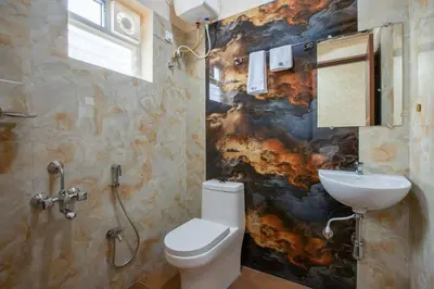 a bathroom with a toilet and a sink at MUGUNDAN 'S SMART STAY in Coimbatore