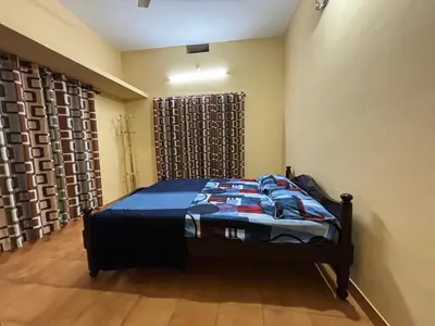 a bedroom with a bed in a room at Kokaris Coorg Homestay in Kushālnagar