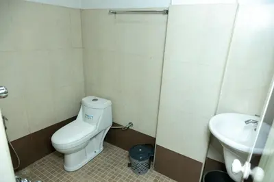 a small bathroom with a toilet and a sink at Hamsted in Kottakkal