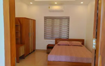 a bedroom with a bed and a window at Homestay- Near to Cochin Airport in Kāladi