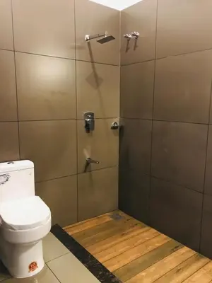 a bathroom with a shower with a toilet at Western Ghats Holiday Home in Kalpetta