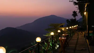 a row of lights on a balcony at night at Vayalada View Point Resort in Kozhikode