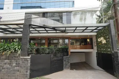 a building with a black gate and a building at Hotel Bluebell in Kozhikode