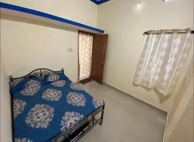 a blue bed in a room with a window at The bluebird residence in Mysore