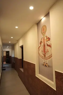 a painting on the wall in a hallway at Kovilakam Achutham in Guruvāyūr