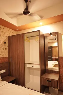 a bedroom with a mirror and a bed at Kovilakam Achutham in Guruvāyūr