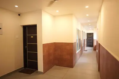 a hallway of a building with a door at Kovilakam Achutham in Guruvāyūr