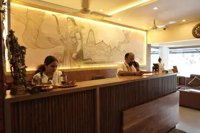 a man and a woman sitting at a bar at Kovilakam Achutham in Guruvāyūr