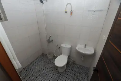 a bathroom with a toilet and a sink at Platinum Airport Lounge by VVP in Nedumbassery