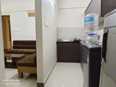 a small kitchen with a sink and a refrigerator at Platinum Airport Lounge by VVP in Nedumbassery