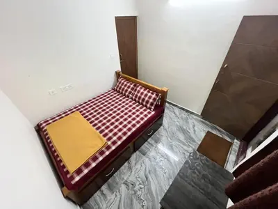 a small bench sitting on a floor in a room at Arasu Homestay in Antarasante