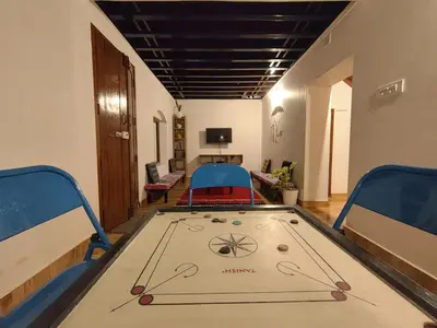 a ping pong table in the middle of a room at Aadhya Homestay 4BHK in Wayanad