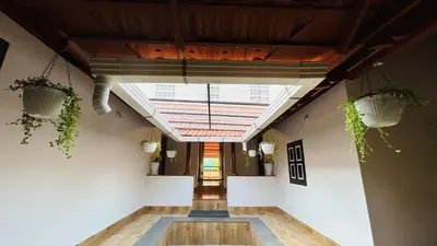 an empty hallway with a skylight and plants at Aadhya Homestay 4BHK in Wayanad