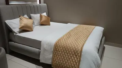 a bed with two pillows on it in a room at Thulasi Avenue Inn in Pollāchi