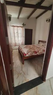 a bedroom with a bed and a marble floor at Pear Tree Luxe Entire 3BHK Villa - Only For Family in Kotagiri