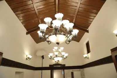 a ceiling with a chandelier in a room at Pear Tree Luxe Entire 3BHK Villa - Only For Family in Kotagiri