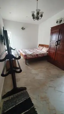 a room with a bed and a chair in a room at Pear Tree Luxe Entire 3BHK Villa - Only For Family in Kotagiri