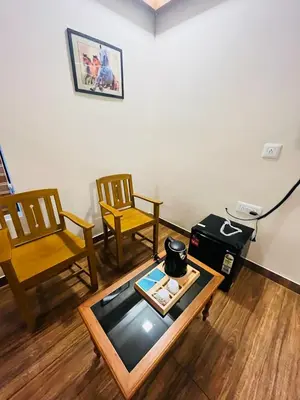 a living room with two chairs and a coffee table at ATHIRAPPILY SREENILAYAM HERITAGE RESORt in Athirappilly