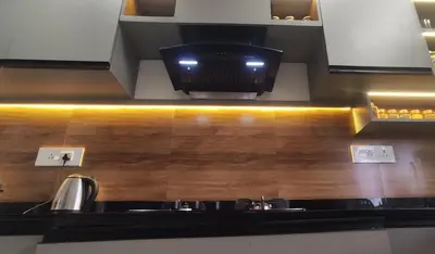 a kitchen with a sink and a tv on the wall at Mountain View Villa in Mukkam