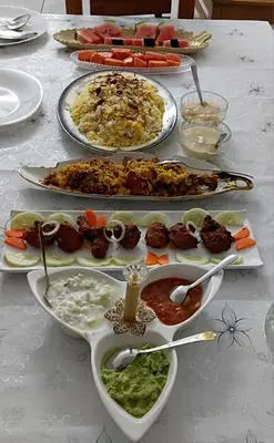 a table with several plates of food on it at UPPU HOMESTAY in Mulappilangād