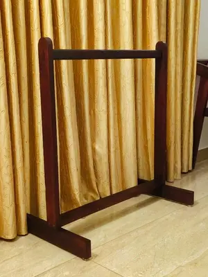 a curtain stand in front of a yellow curtain at Ananda Holiday Home in Ambalavayal